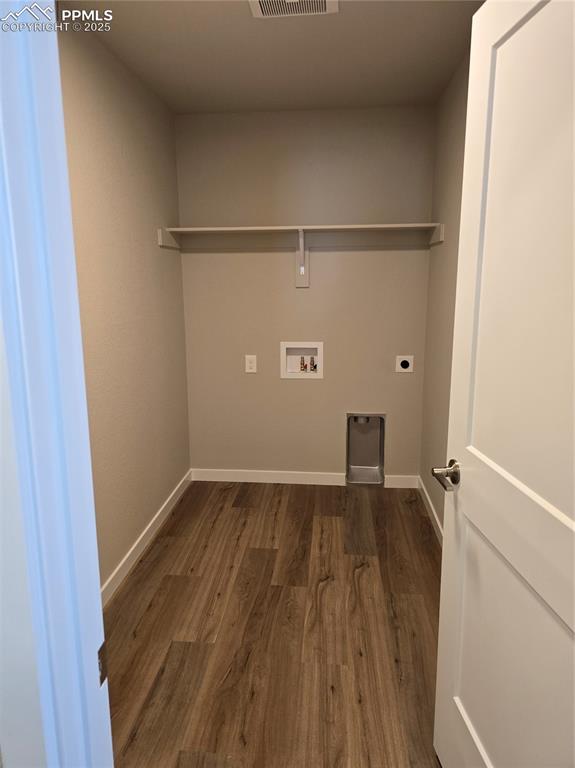 Image 11 of 15: Laundry room featuring dark wood-type flooring, washer hookup, and electric