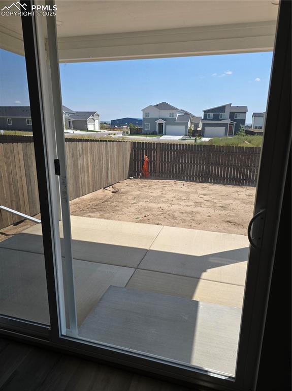 Image 2 of 15: Fenced backyard with a residential view and a patio