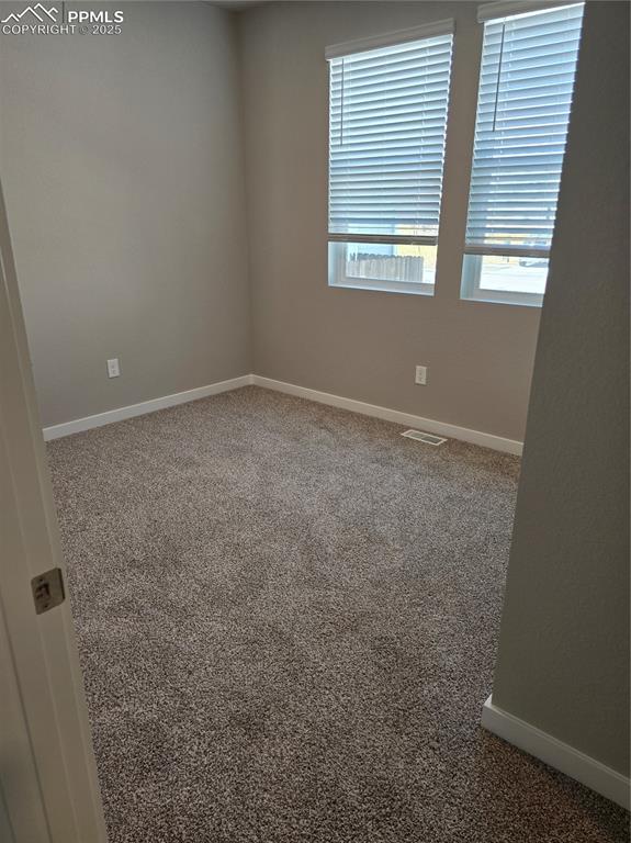 Image 8 of 15: Empty room featuring carpet and healthy amount of natural light