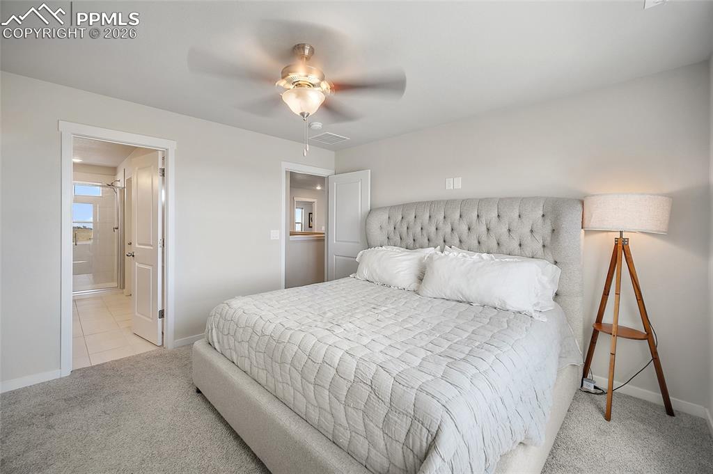 Image 18 of 41: Primary bedroom with view to primary bath and loft