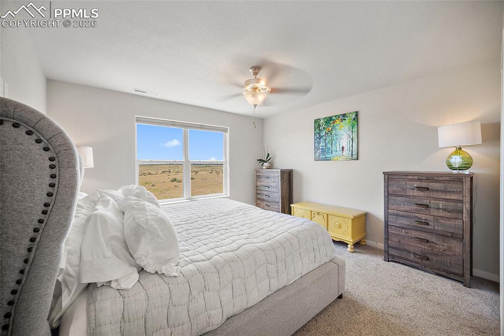 Image 19 of 41: Primary bedroom with endless view of open space and beautiful mountains (to