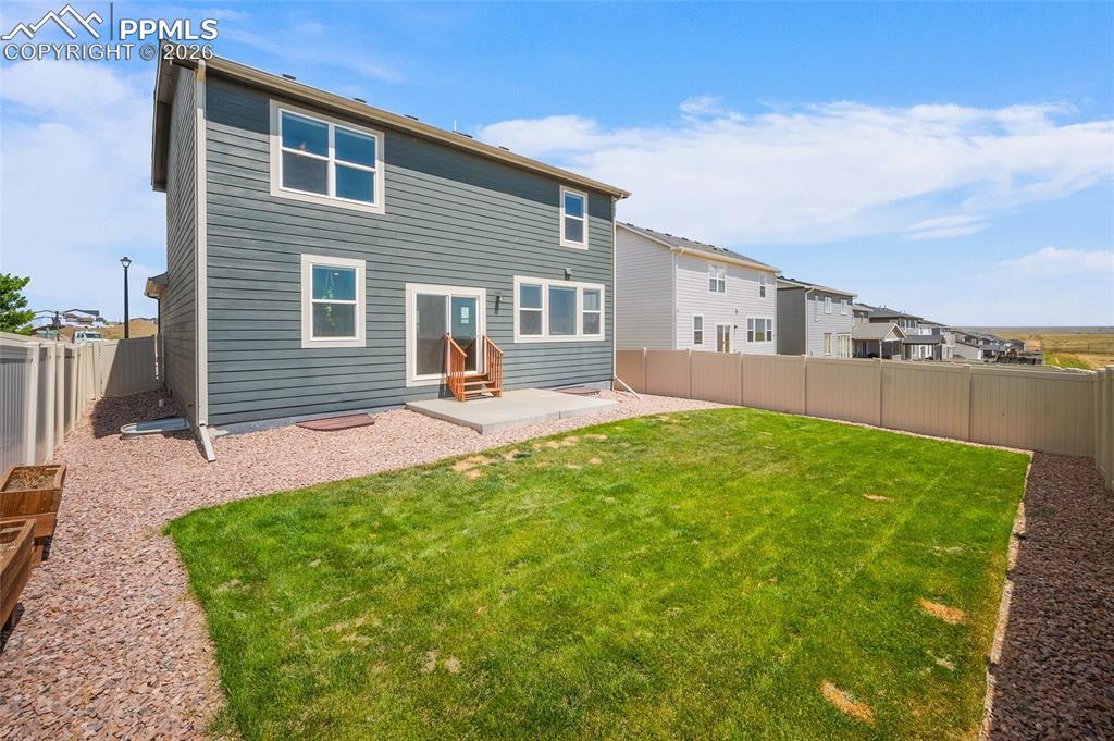 Image 33 of 41: Professionally landscaped backyard complete with sprinkler system