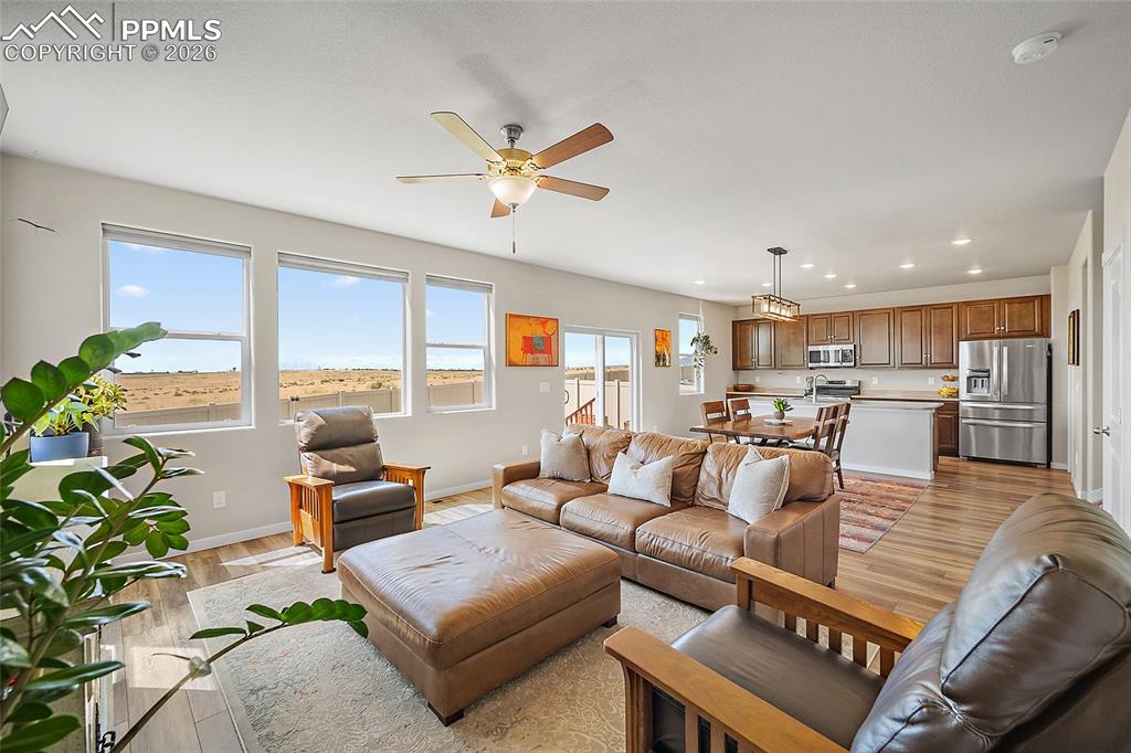 Image 9 of 41: Living room with exterior view of open space and interior view of dining ar