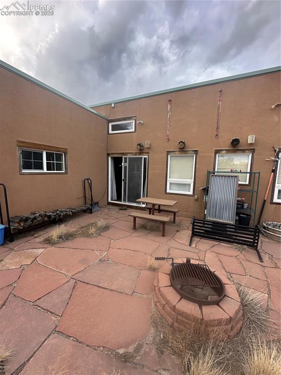 Image 3 of 6: Back Patio with Fire Pit