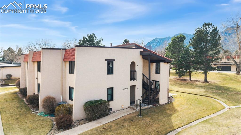 Image 30 of 35: Stucco exterior and tile roof