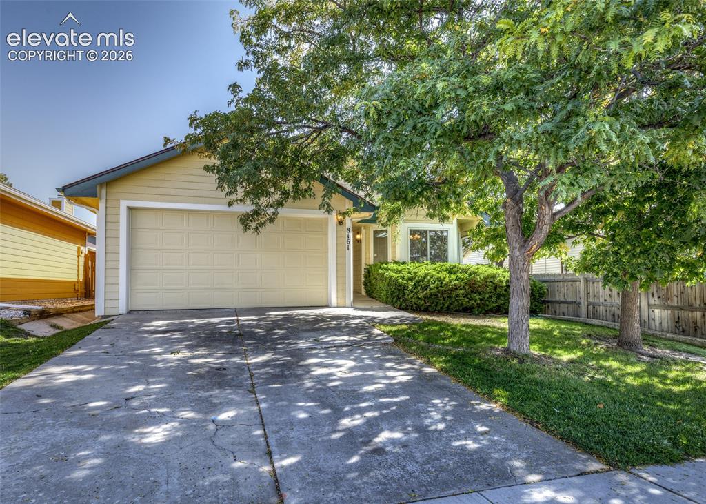 Image 1 of 22: Siding exterior with an attached garage, concrete driveway, and front lawn