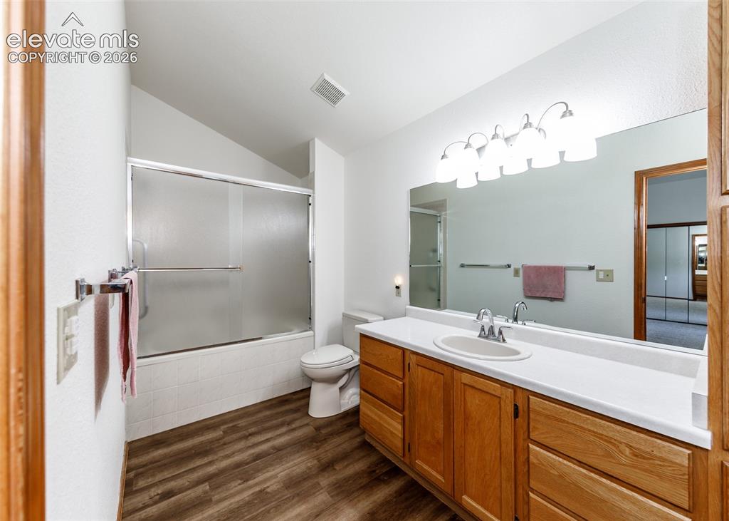 Image 13 of 22: Wood-finish flooring, wood cabinetry, built-in vanity with integrated sink,
