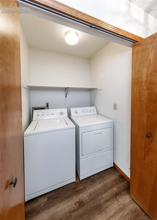 Image 20 of 22: Dedicated laundry area featuring wood-finish flooring, overhead lighting, a