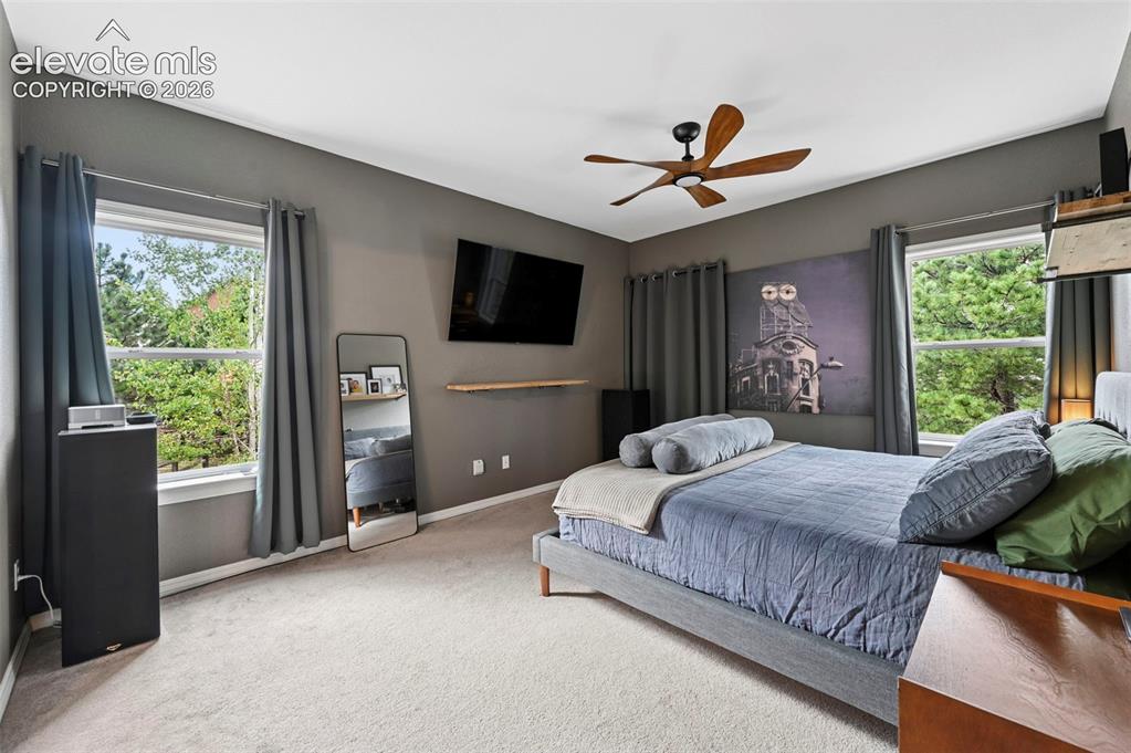 Image 15 of 43: Recessed window frames, wood-finish ceiling fan, wall-mounted floating shel