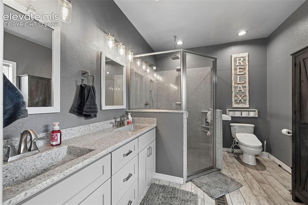 Image 25 of 43: Dual vanity with undermount sinks, stone-finish countertops, and chrome fix