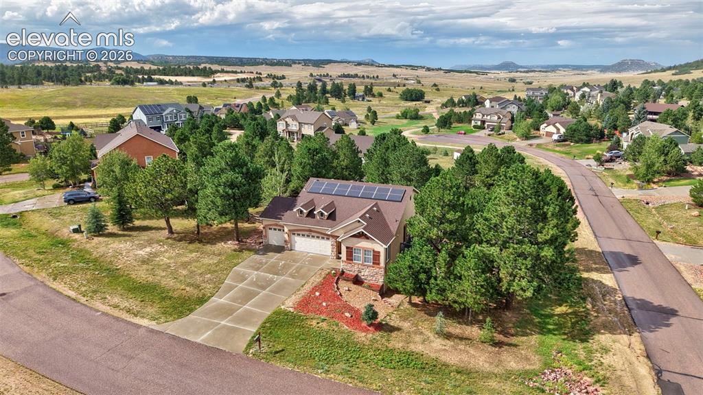 Image 40 of 43: Residential property featuring a concrete driveway, attached garage, and so