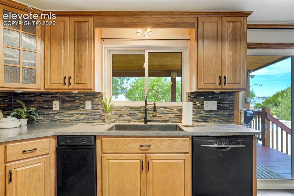Image 10 of 44: Trash compactor and custom cabinetry. 