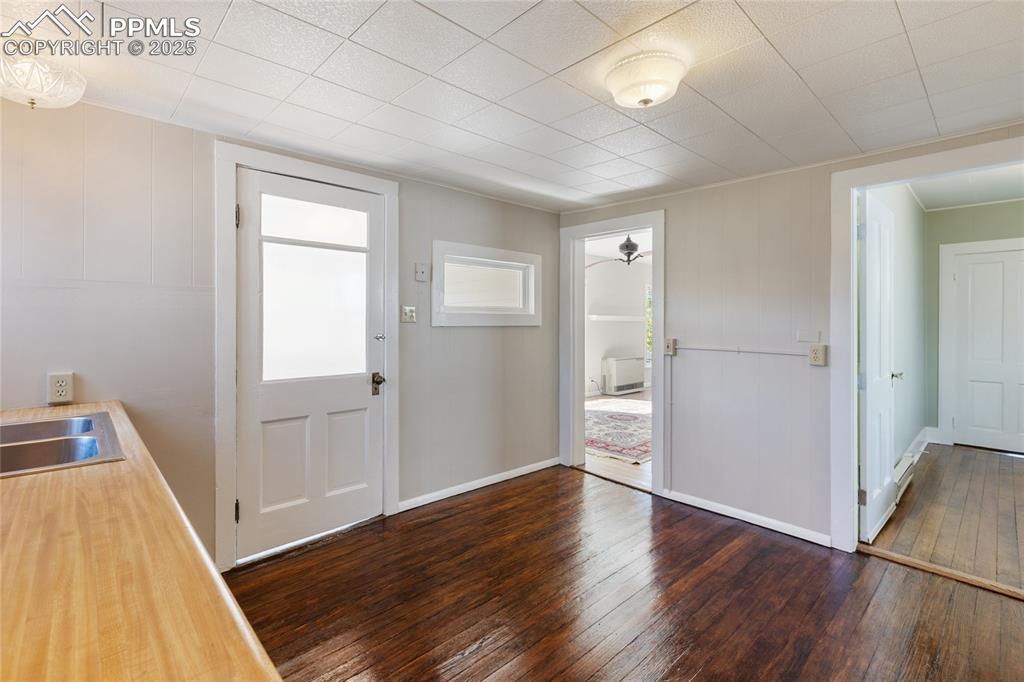 Image 19 of 49: Foyer with dark wood-style floors and baseboards