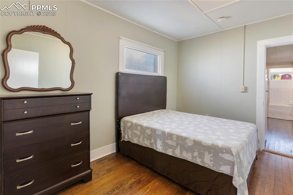 Image 25 of 49: Bedroom featuring dark wood-style flooring