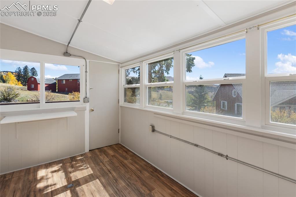 Image 34 of 49: Unfurnished sunroom with lofted ceiling