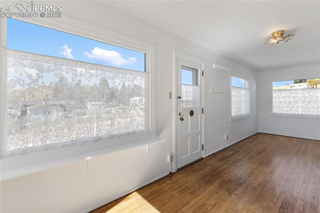 Image 8 of 49: Entrance foyer with dark wood-type flooring and baseboards