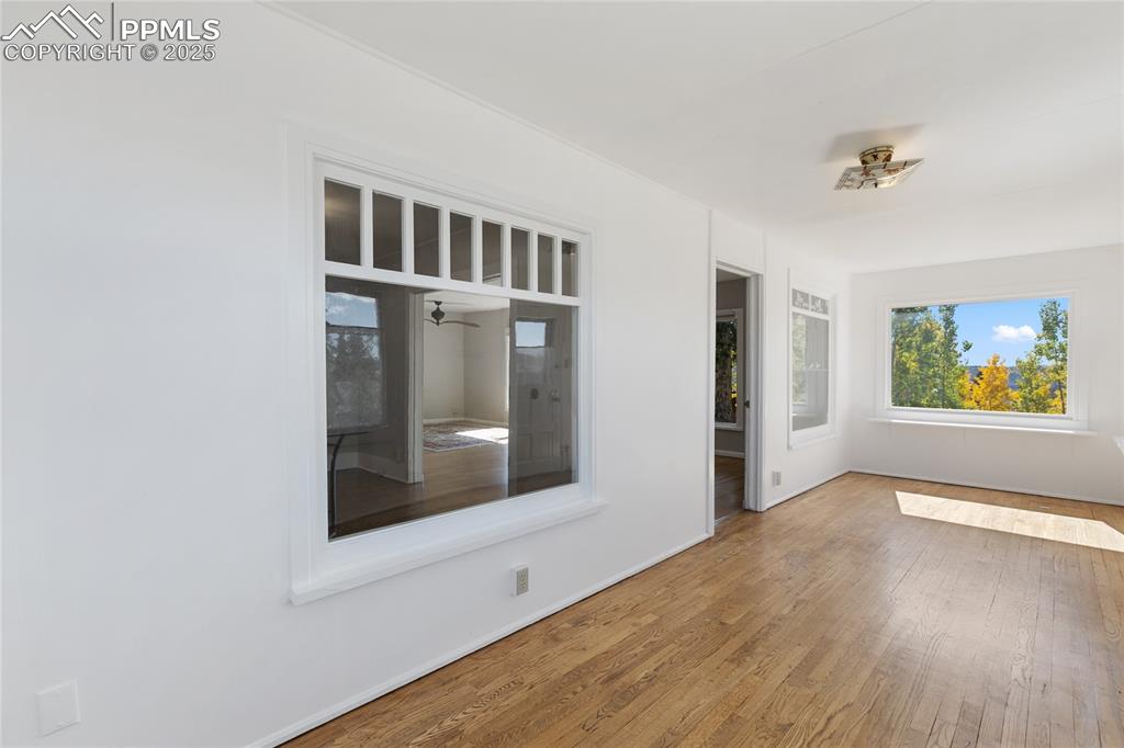 Image 9 of 49: Spare room with wood finished floors and baseboards