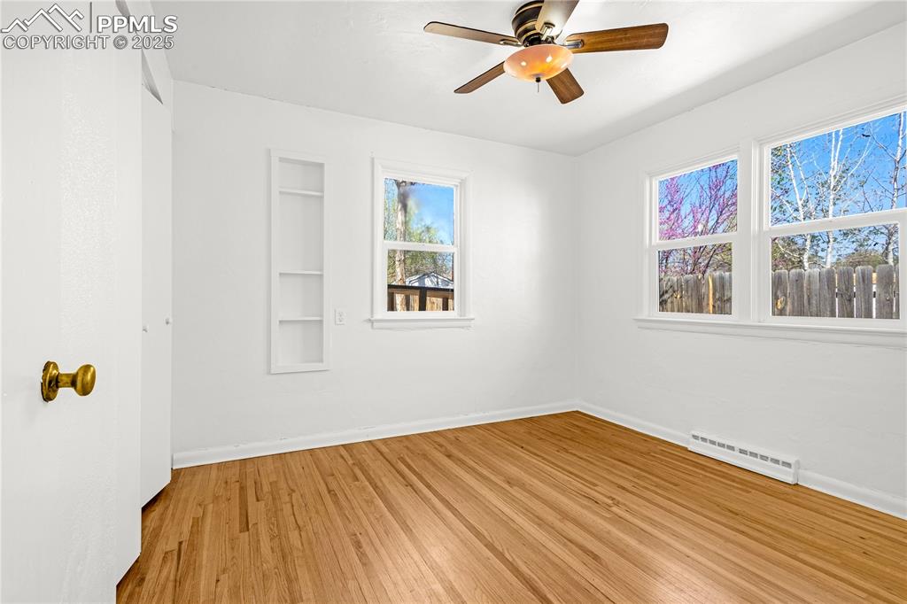 Image 17 of 25: Empty room featuring light wood finished floors, baseboards, visible vents,