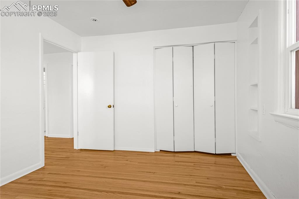 Image 20 of 25: Unfurnished bedroom with baseboards, light wood-style floors, and a closet
