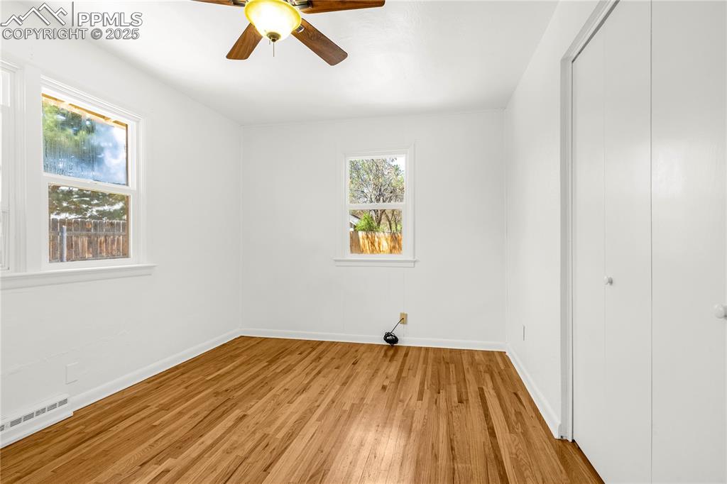 Image 21 of 25: Unfurnished bedroom with baseboard heating, a ceiling fan, a closet, light