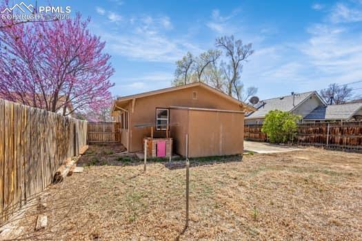 Image 24 of 25: Back of property with a fenced backyard