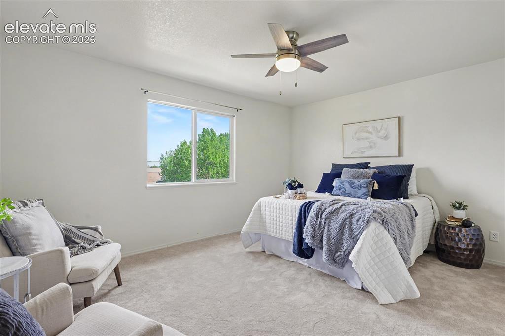 Image 16 of 41: Bedroom featuring a ceiling fan with integrated lighting, a double-pane win