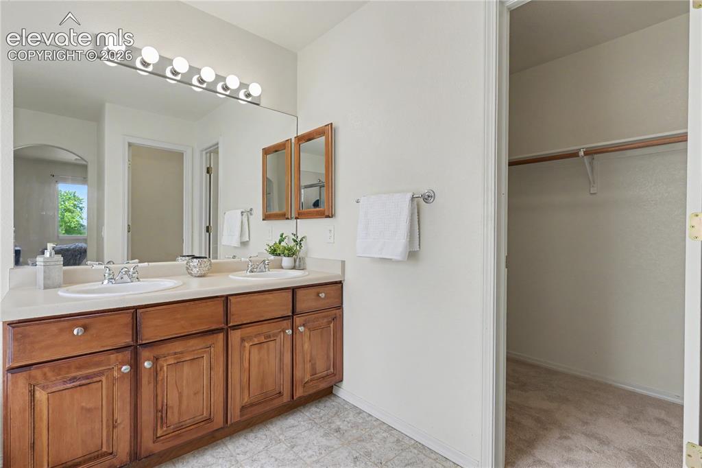 Image 20 of 41: Double vanity with integrated sinks and a light-toned countertop, set again