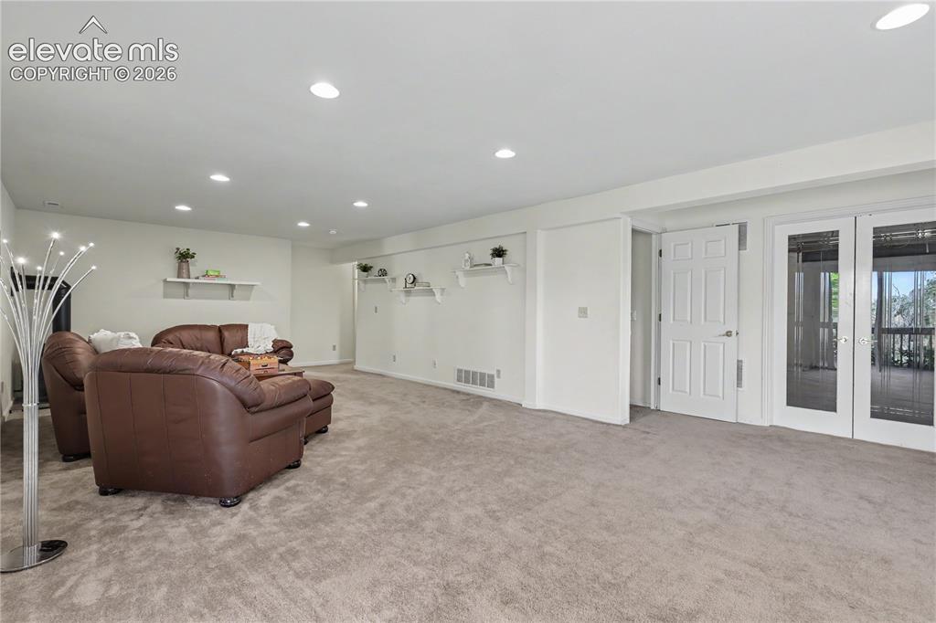 Image 30 of 41: Spacious room featuring neutral carpeting, recessed lighting, white walls,