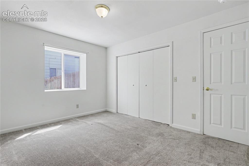 Image 32 of 41: Neutral-toned room featuring a single window, a flush mount ceiling light,