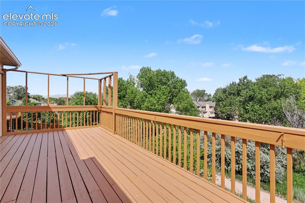 Image 37 of 41: Spacious outdoor deck featuring wooden decking and railing