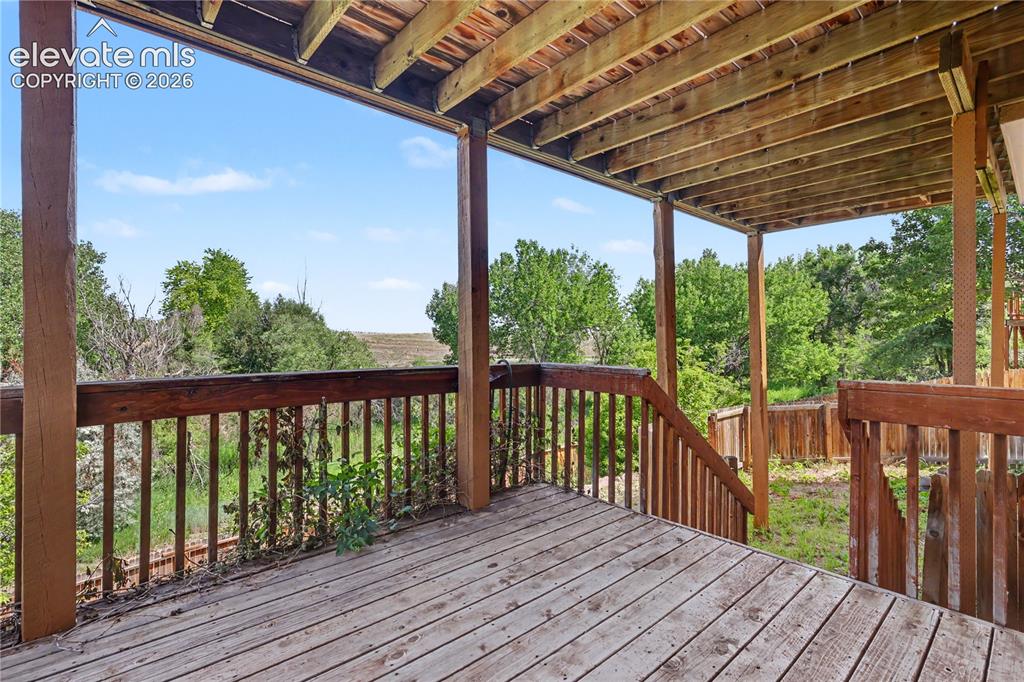 Image 38 of 41: Spacious wood-finish deck featuring a full railing system, exposed wood joi