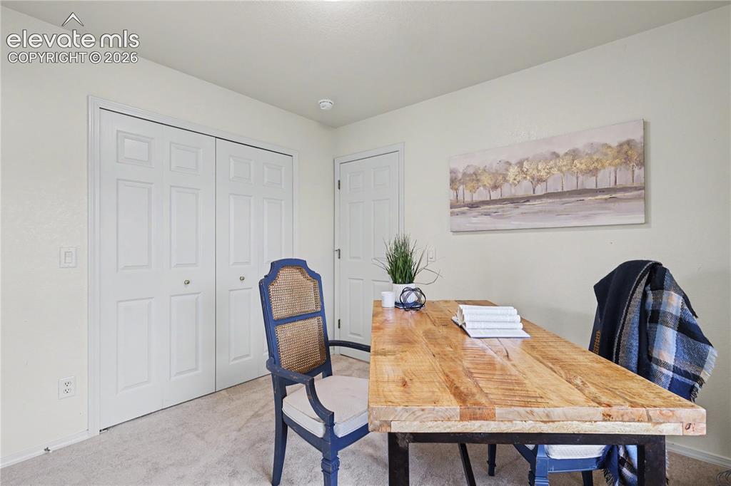 Image 8 of 41: Bedroom featuring plush carpet, white walls, and a pair of bi-fold closet d