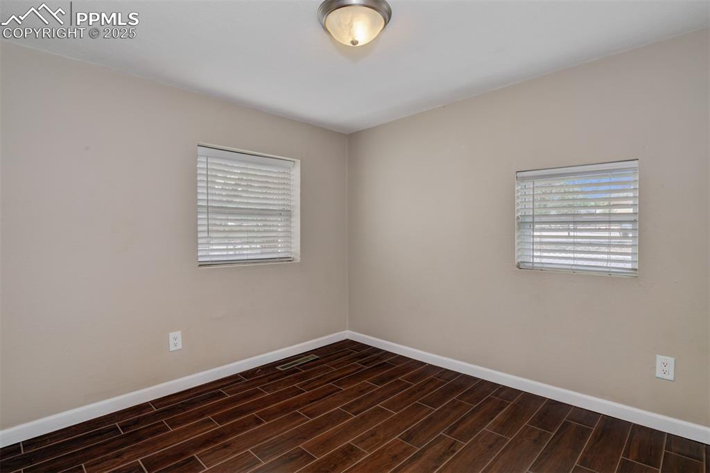 Image 13 of 22: Unfurnished room featuring baseboards and wood finish floors