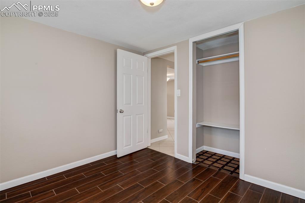 Image 14 of 22: Unfurnished bedroom with wood finish floors and a closet