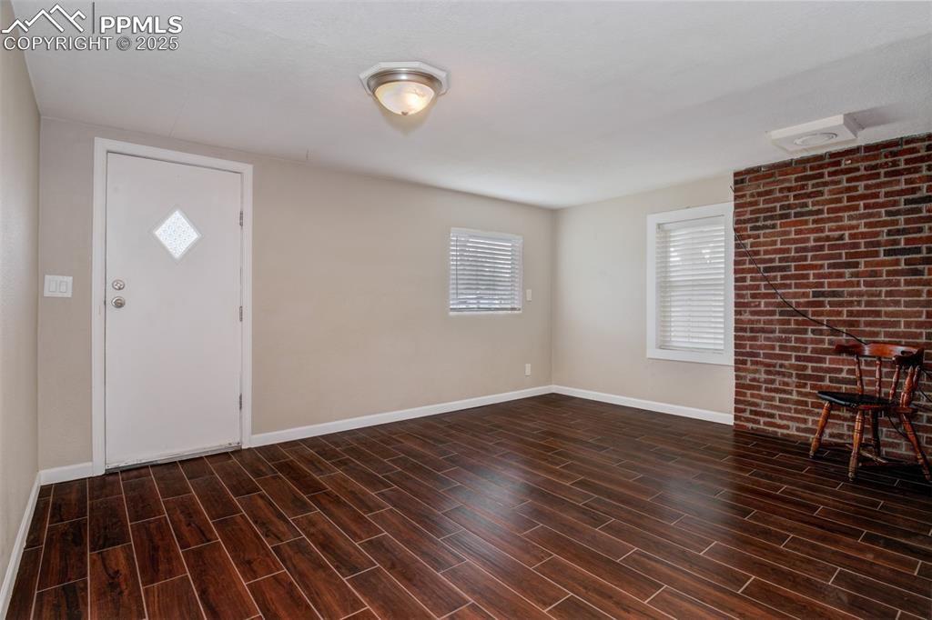 Image 7 of 22: Entrance foyer featuring baseboards and wood tiled floors