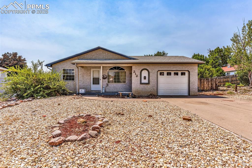 Image 2 of 37: View of front facade featuring a porch, concrete driveway, an attached gara