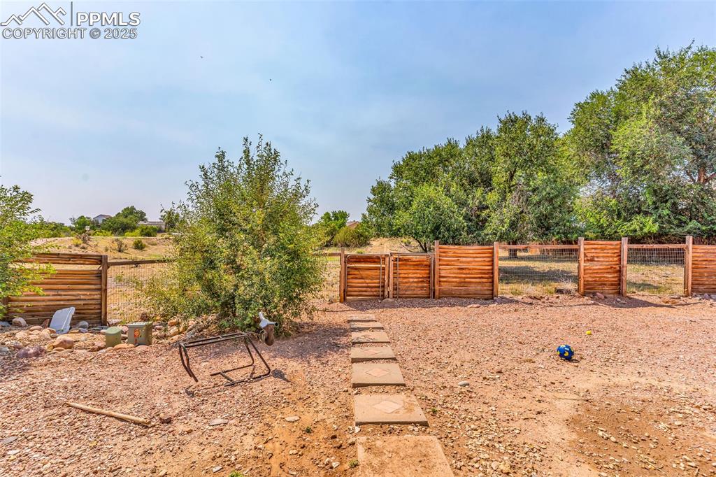 Image 22 of 37: View of yard featuring a gate
