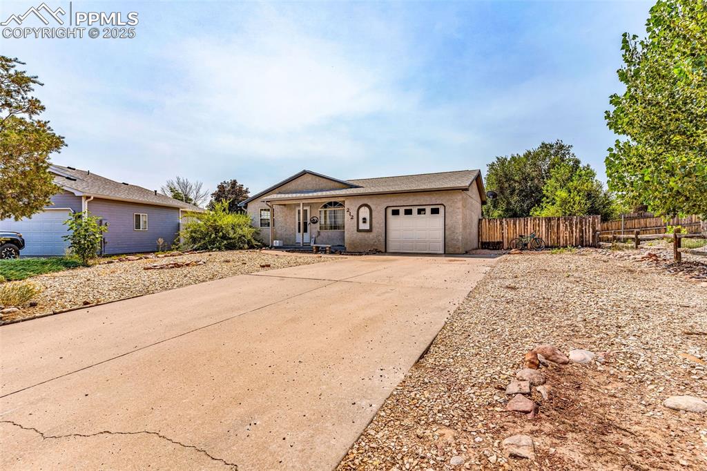 Image 3 of 37: View of front of house with driveway and a garage