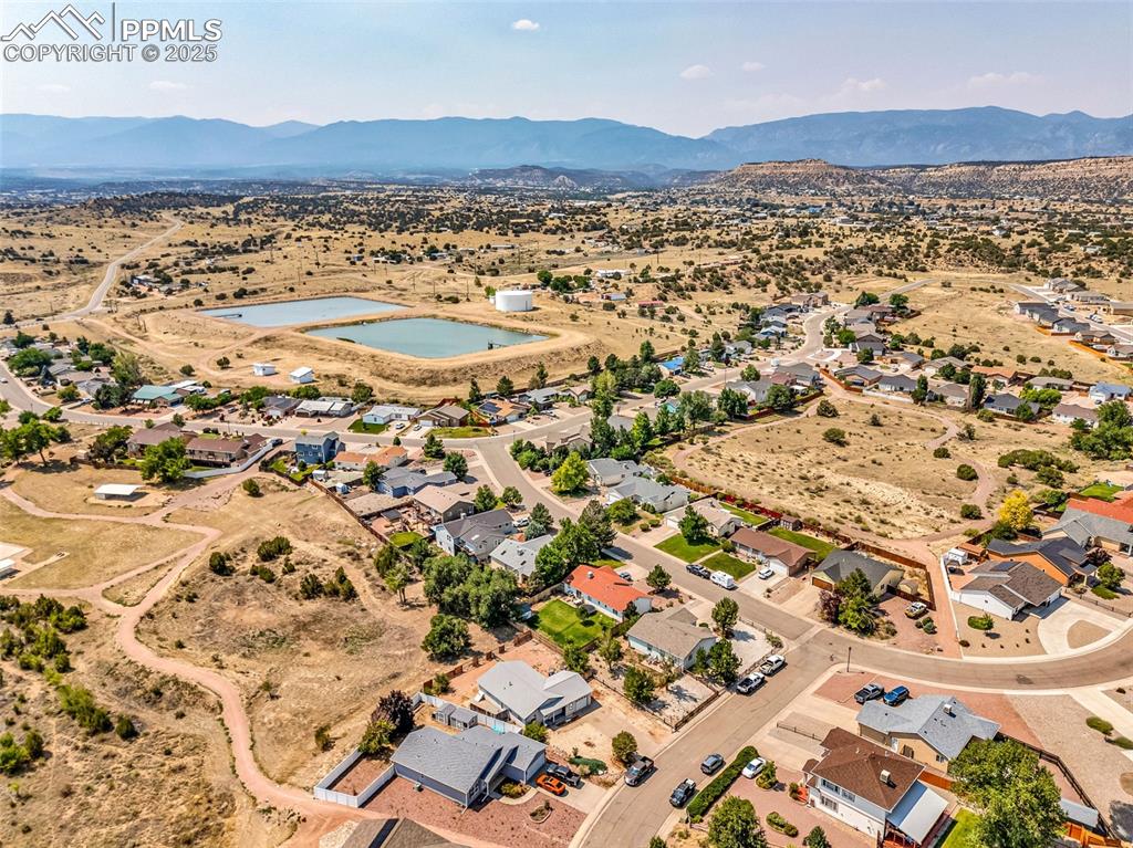 Image 34 of 37: Aerial view of property and surrounding area with nearby suburban area and 