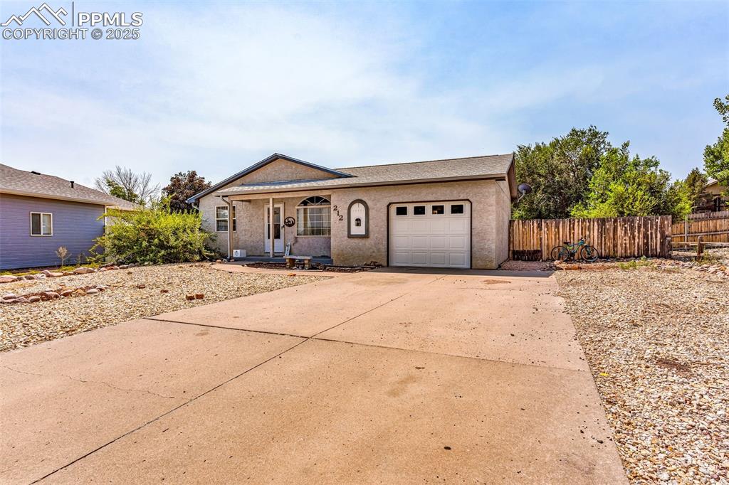 Image 4 of 37: View of front of property with concrete driveway, a porch, and a garage