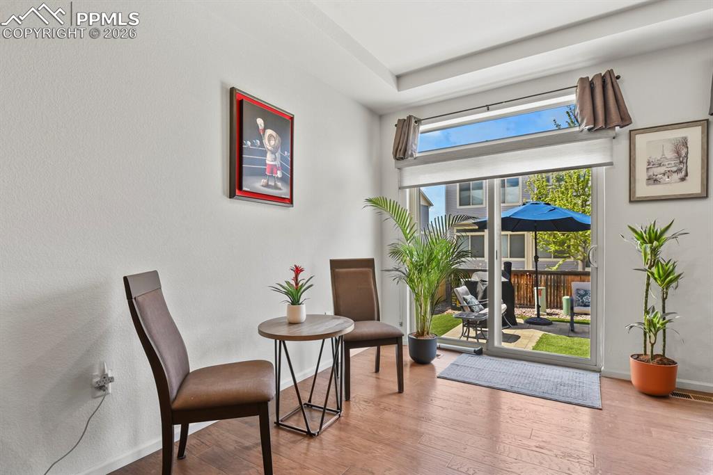 Image 18 of 39: Dining area with a sliding glass door opening to the backyard with nice pat