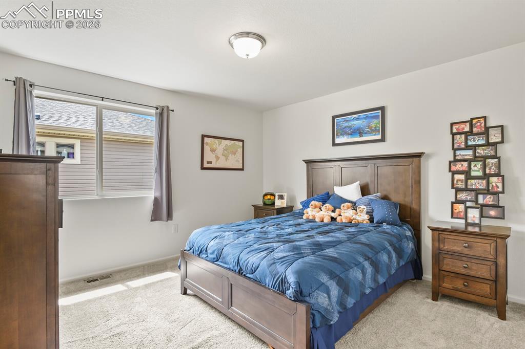 Image 30 of 39: Upper level bedroom with attached bathroom