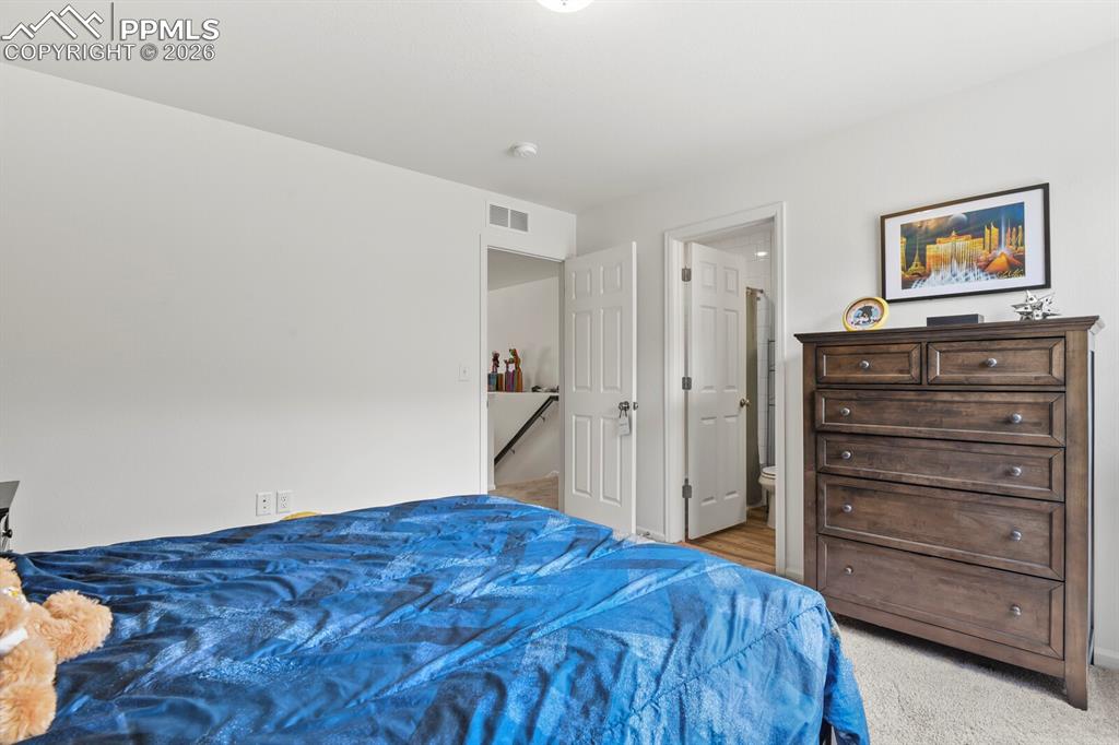 Image 31 of 39: Upper level bedroom with attached full private bathroom