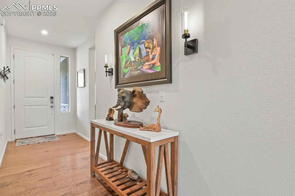 Image 6 of 39: Entryway featuring wood-finish flooring and recessed lighting