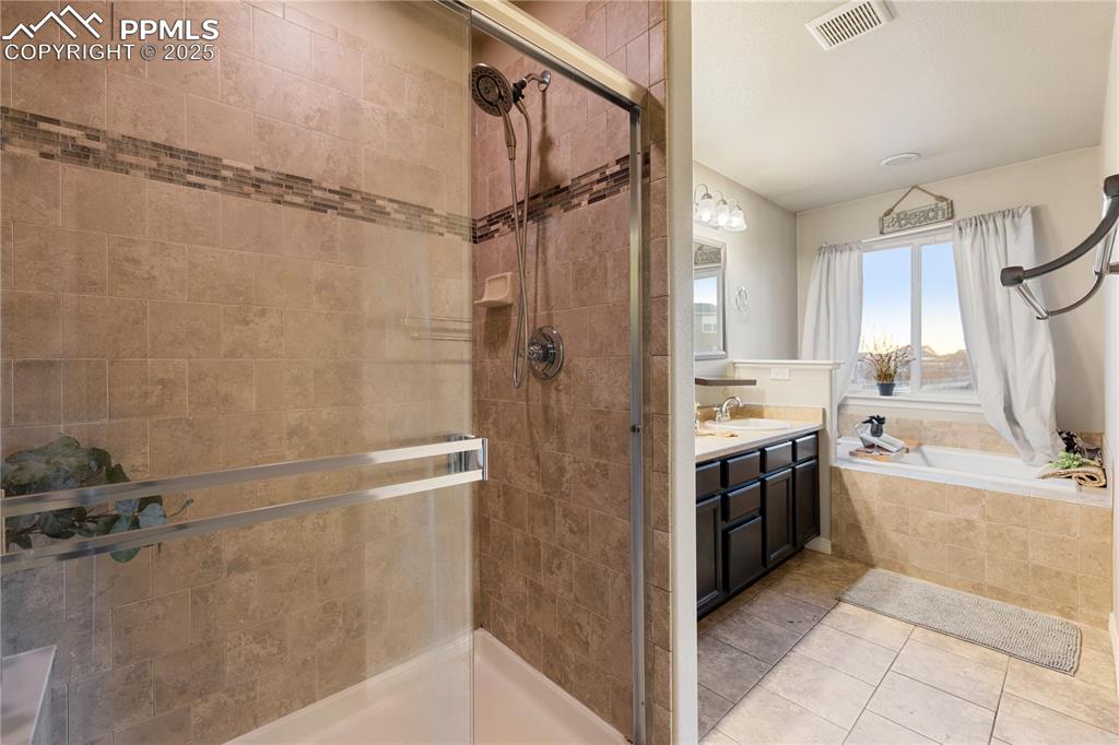 Image 22 of 46: Bathroom featuring tile patterned floors, vanity, and independent shower an