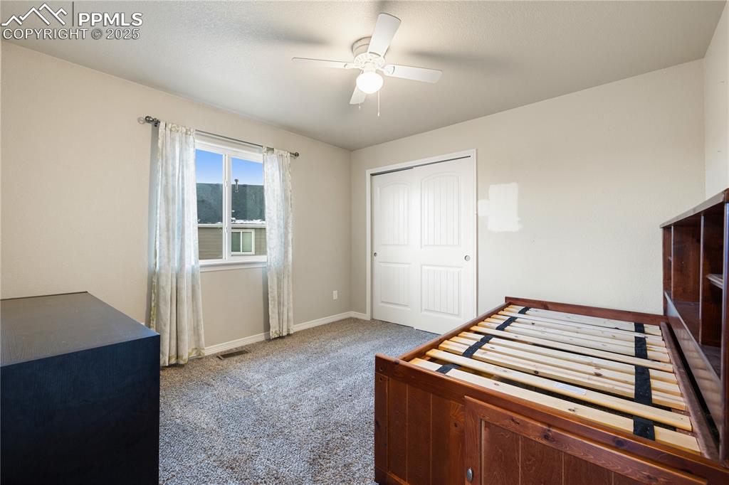 Image 26 of 46: Carpeted bedroom with ceiling fan and a closet