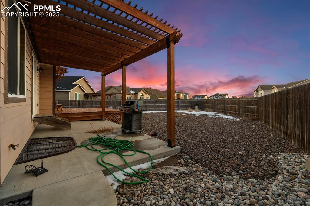Image 42 of 46: Yard at dusk featuring a pergola and a patio