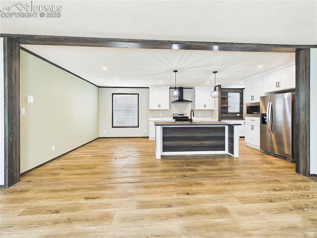 Image 11 of 50: Kitchen & Dining Area – Contemporary kitchen with a large island, pendant l