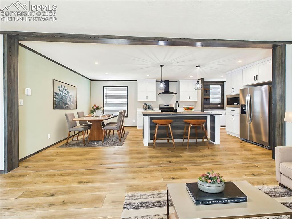 Image 12 of 50: (Virtually Staged) Stylish kitchen featuring crisp cabinetry, modern finish