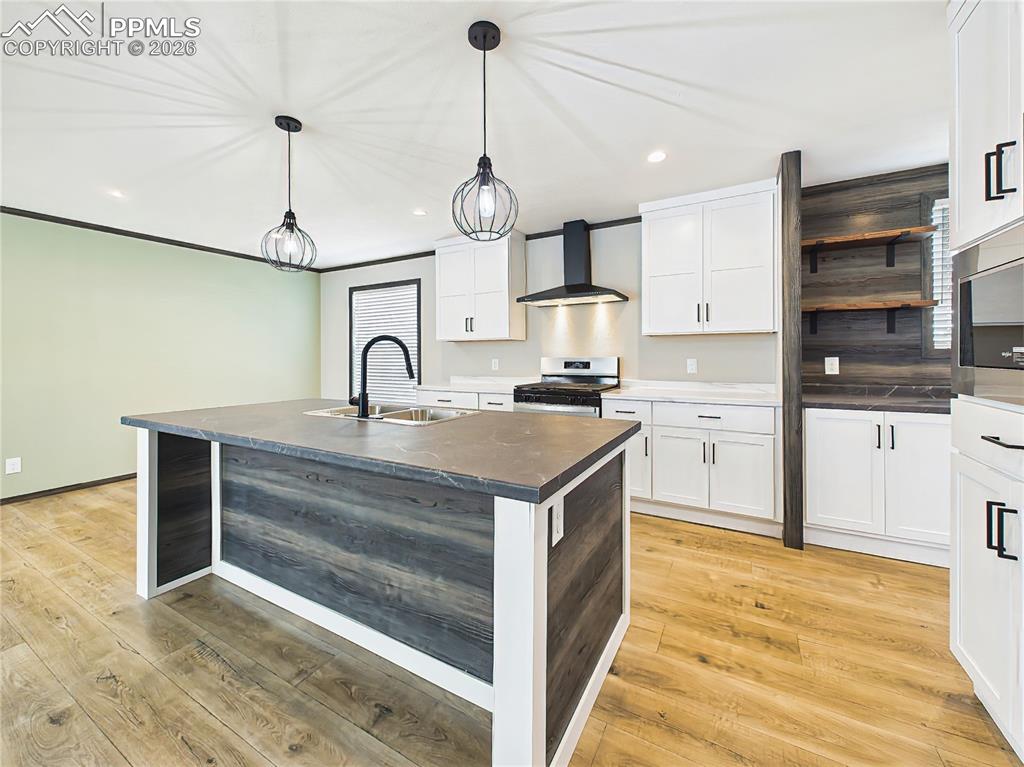 Image 18 of 50: Kitchen – Stylish open-concept kitchen featuring a large island with seatin